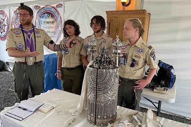 Rabbi Avi Hoffman (left) introduces the three Jewish Scout—from left: Gabriel and Joshua Greengas, and Coulton Perrmann—who each became a bar mitzvah at the 2023 National Scout Jamboree in Glen Jean, W.V., on July 24, 2023. Photo by the National Boy Scouts of America (BSA).