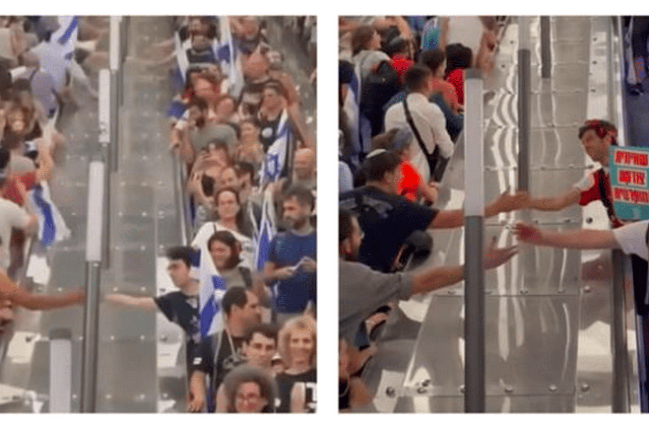 On July 23, in Jerusalem’s central train station, Israelis heading to protest for judicial reform in Tel Aviv and against judicial reform in Jerusalem, shake hands. Photo courtesy of StandWithUs.