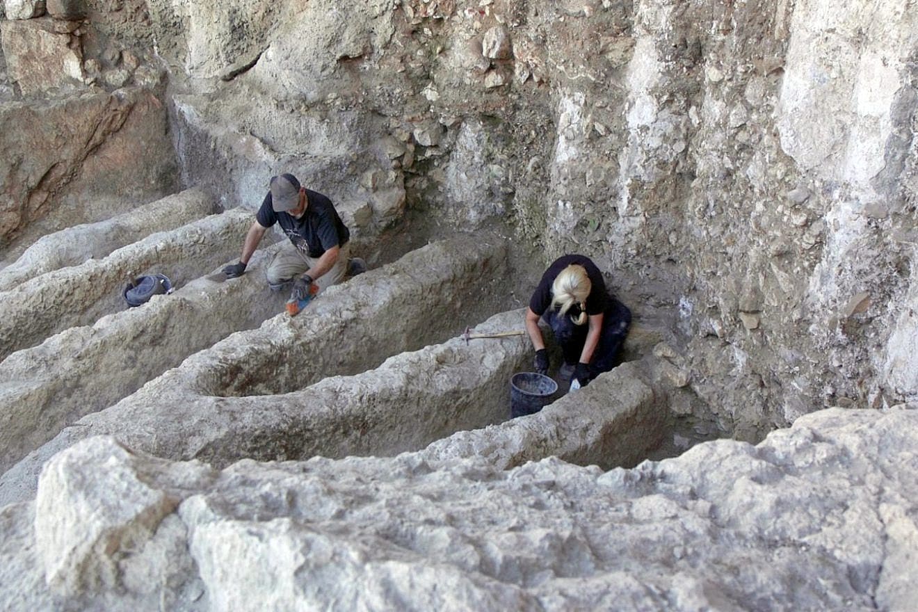 Researchers examine the mysterious channels unearthed in the City of David National Park in Jerusalem. Photo by Emil Aladjem/Israel Antiquities Authority.