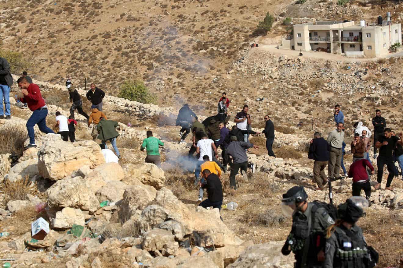 Palestinians clash with Israeli security forces as a bulldozer demolishes a Palestinian house in  Hebron, Oct. 25, 2022. Photo by Wisam Hashlamoun/Flash90.