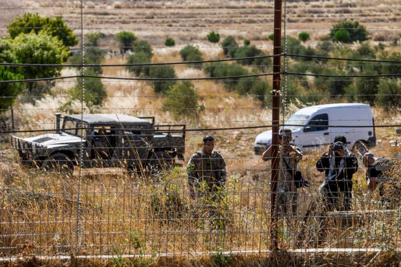 Lebanese soldiers and Hezbollah fighters taking pictures during a fire that spread from the Lebanese side of the border to the Israeli side of the border in Kibbutz Malkia, northern Israel, July 28, 2023. Photo by Ayal Margolin/Flash90.