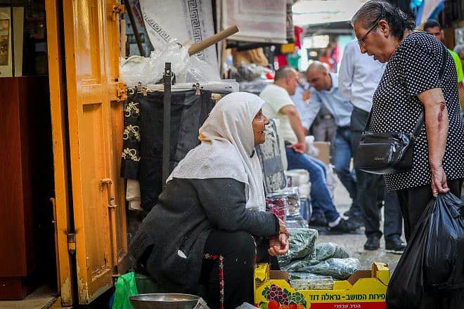 People shop in the Old City of Jerusalem's Muslim Quarter, June 11, 2023. Photo by Jamal Awad/Flash90.
