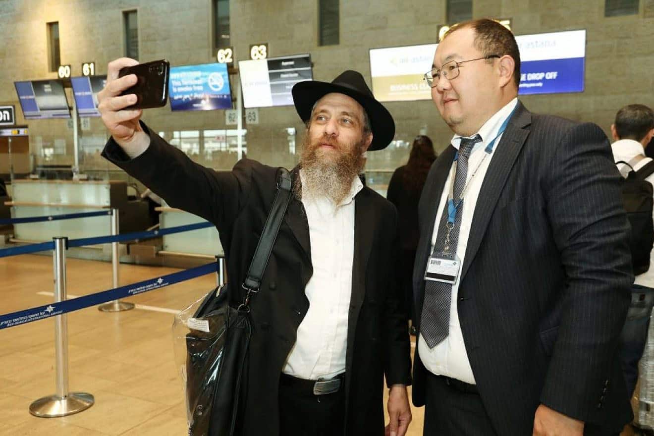 Israeli passengers at Tel Aviv's Ben-Gurion International Airport celebrate with Air Astana staff the inaugural direct flight between Israel and Kazakhstan on Sept. 7, 2023. Photo by Gideon Markowicz/TPS.