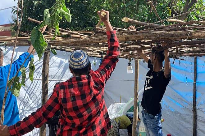 Ethiopian Jews put up a sukkah for the Jewish holiday of Sukkot. Credit: Courtesy of Struggle to Save Ethiopian Jews.