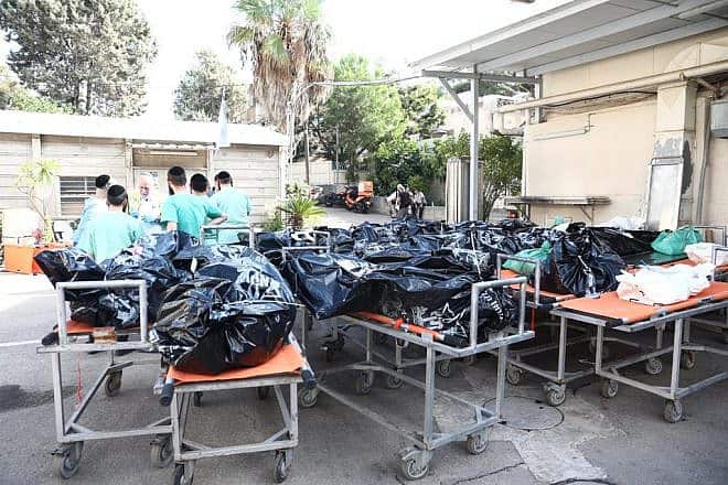Trucks filled with dead bodies from Israeli communities near the Gaza border arrive at Abu Kabir Forensic Research Laboratory in Tel Aviv for identification, Oct. 16, 2023. Photo by Gideon Markowicz/TPS.