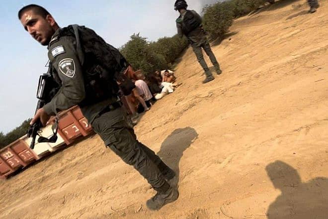 Israel Border Police officers rescue people during Hamas's attack on the Supernova music festival near Kibbutz Re'im, Oct. 7, 2023. Credit: Courtesy of Neta David.