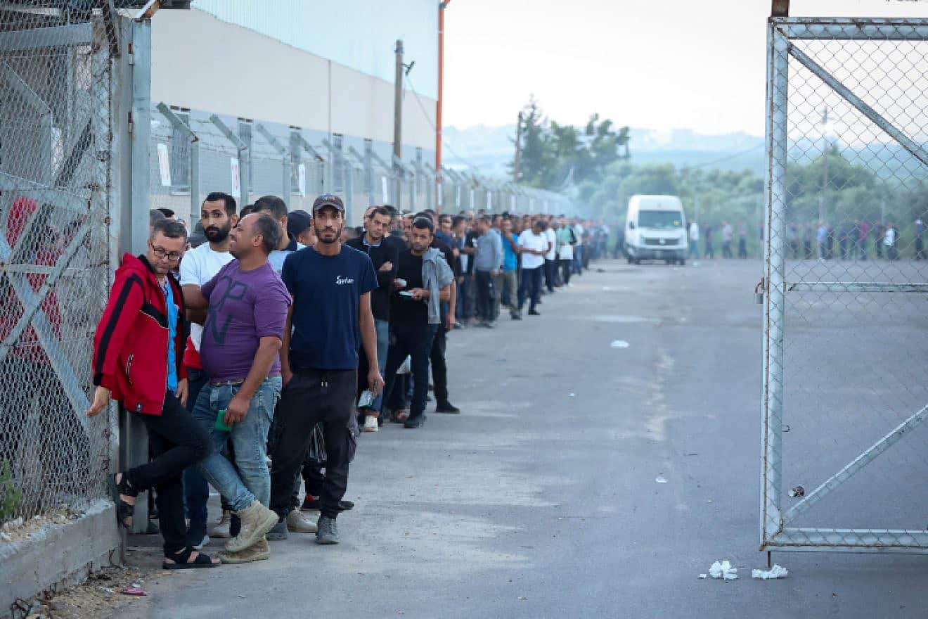 Workers from the Gaza Strip stand in line to enter Israel through the Erez border crossing, Sept. 28, 2023. Photo by Atia Mohammed/Flash90.
