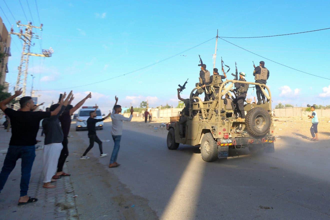 Hamas and Palestinian terrorists in a stolen IDF vehicle at the Erez border crossing between Israel and the northern Gaza Strip, Oct. 7, 2023. Photo by Atia Mohammed/Flash90.