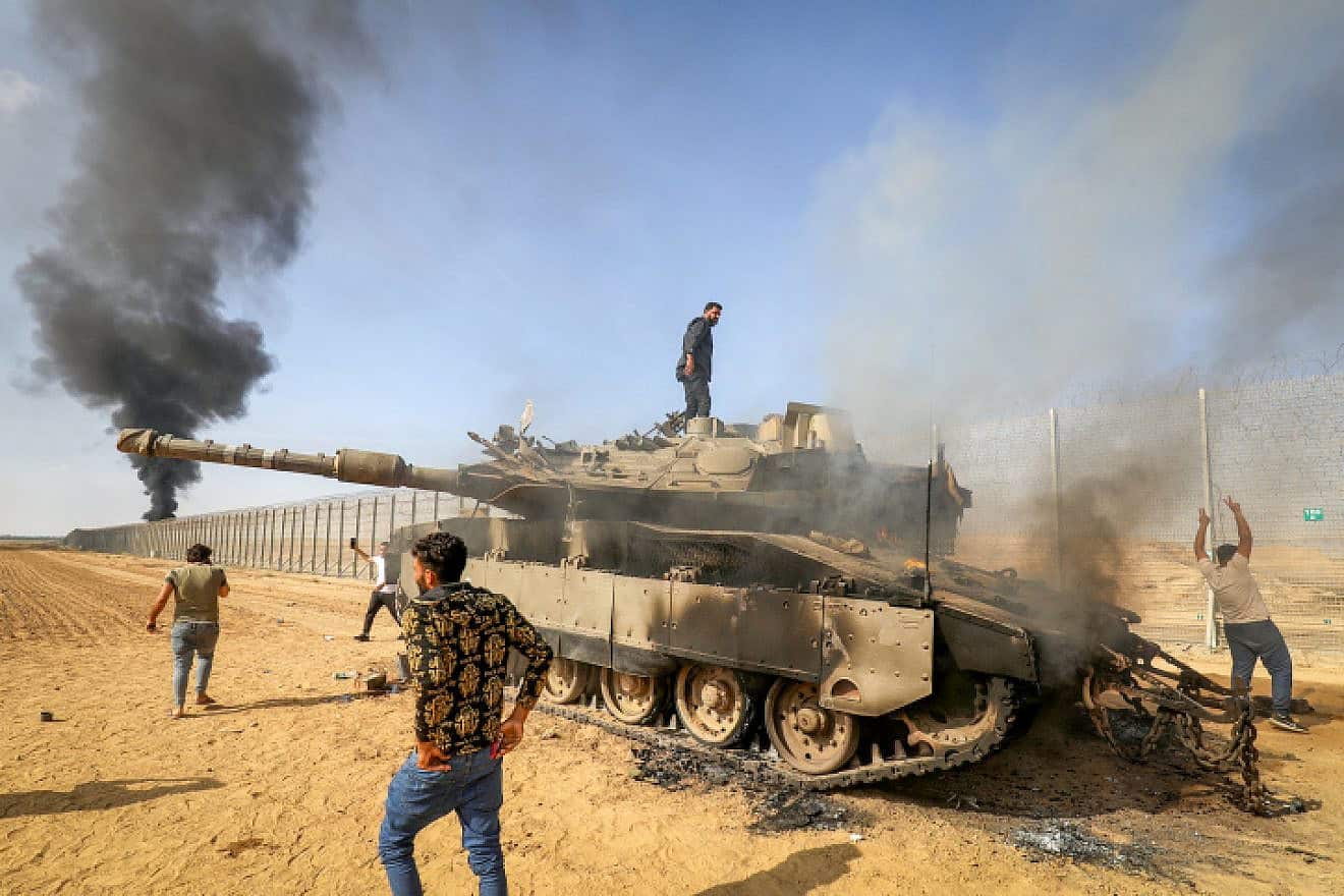 Palestinians take control of an Israeli tank after crossing the border fence with Israel from Khan Yunis in the southern Gaza Strip, Oct. 7, 2023. Photo by Abed Rahim Khatib/Flash90.