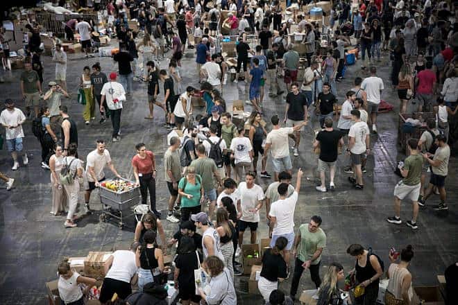 Israeli citizens pack donations of food and other necessities for Israeli soldiers and citizens in the south, in Tel Aviv, Oct. 9, 2023. Photo by Miriam Alster/Flash90.