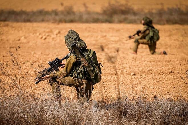 Israeli soldiers take position on a main road near the Israeli-Gaza border, Oct. 10, 2023. Photo by Chaim Goldberg/Flash90.