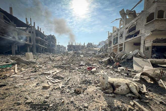Palestinians walk through rubbles of houses destroyed by Israeli airstrikes in the Jabalia area in the northern Gaza Strip, Oct. 11, 2023. Photo by Atia Mohammed/Flash90.