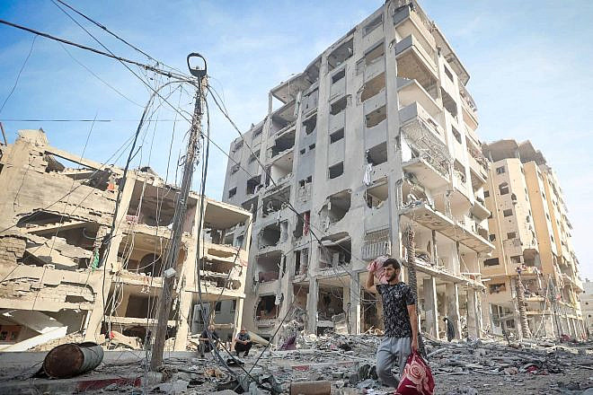 A Palestinian walks past the rubble of houses destroyed by Israeli airstrikes in the Jabalia area in the northern Gaza Strip, Oct. 11, 2023. Photo: Atia Mohammed/Flash90