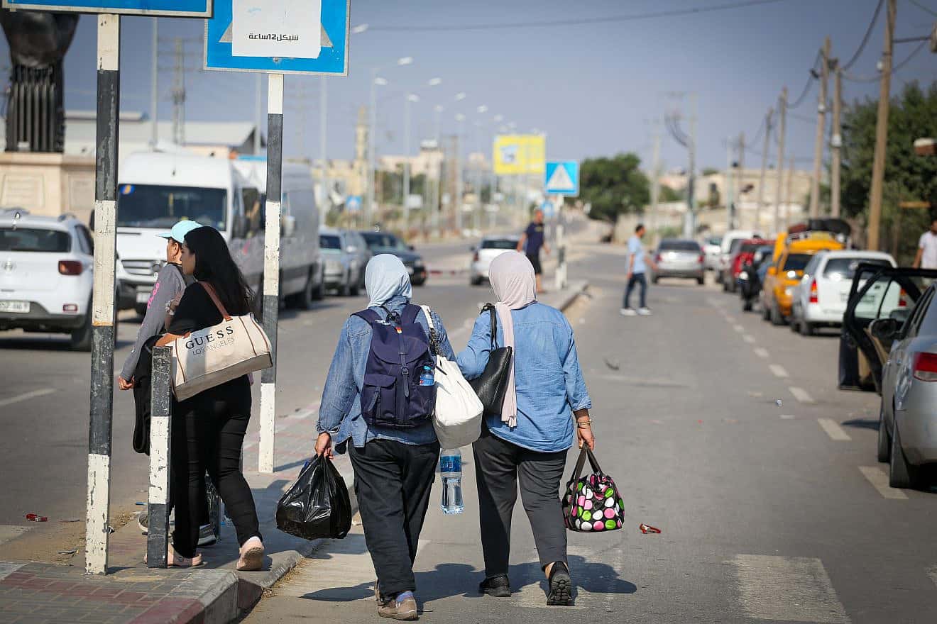 Palestinians who flee from their homes wait at the Rafah border crossing to Egypt in the southern Gaza Strip, on Oct. 14, 2023. Photo by Atia Mohammed/Flash90.
