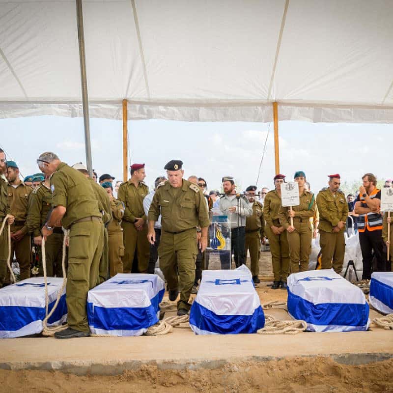 Mourners attend the funeral of five members of the Kotz family, murdered by terrorists on Oct. 7 in Kfar Aza, on Oct. 17, 2023. Photo by Flash90.