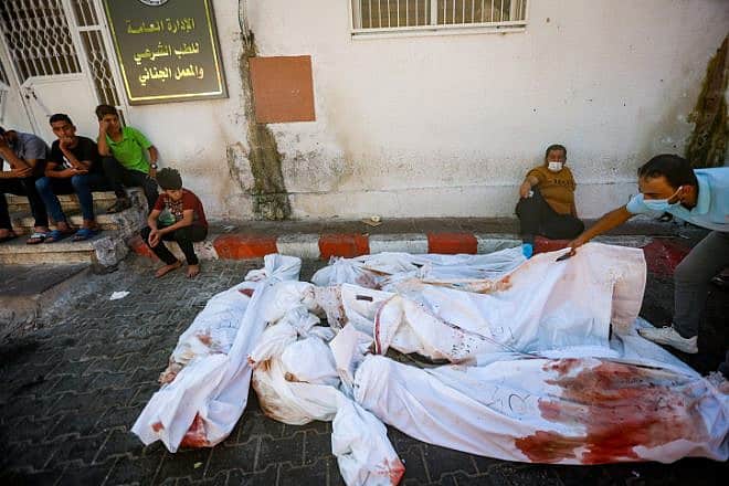 Palestinians observe some of the damage caused by an explosion at Al-Ahli Arab Hospital in Gaza City, Oct. 18, 2023. Photo by Atia Mohammed/Flash90.