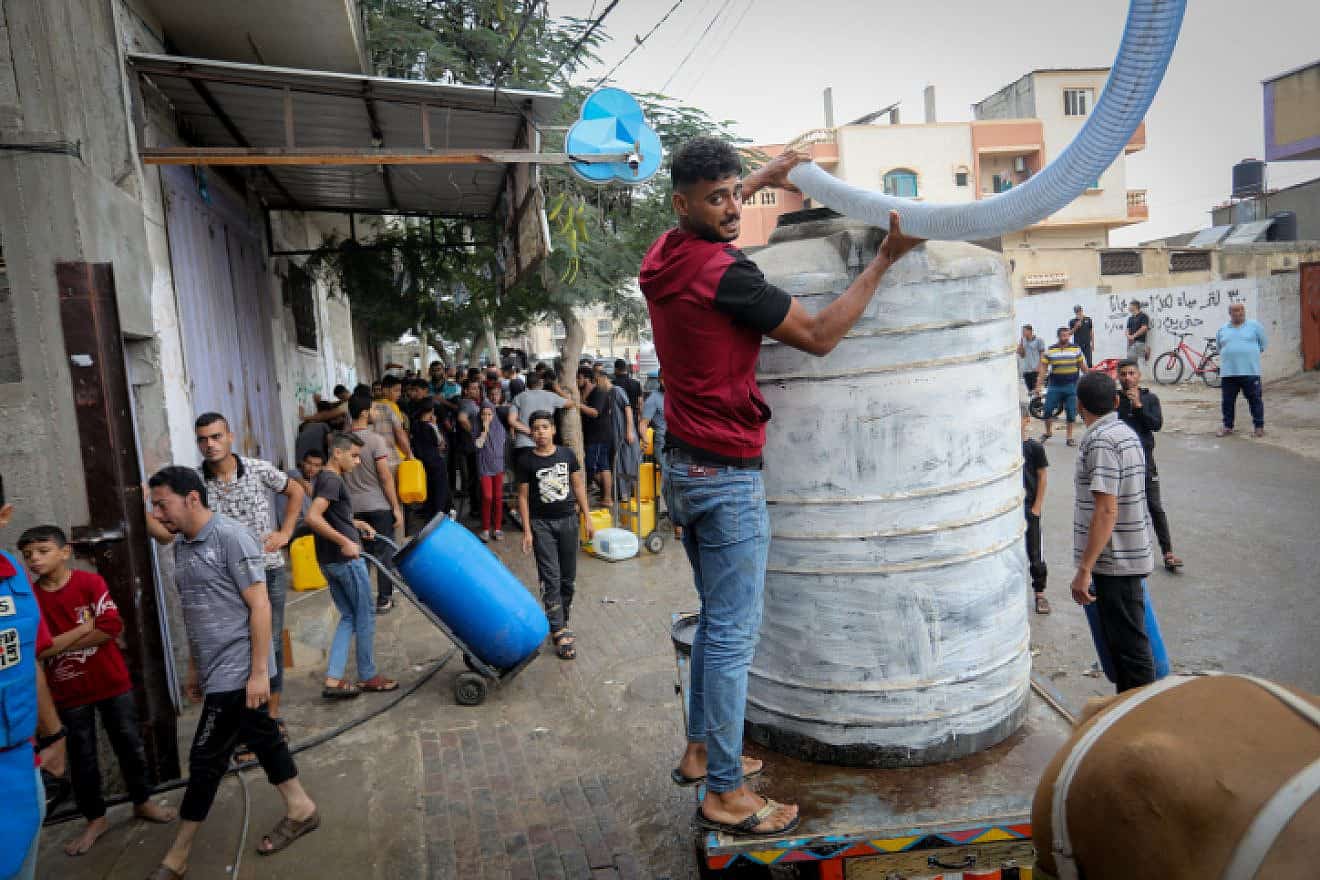 Palestinians wait to collect water using horse- and donkey-drawn carts, in Rafah in the southern Gaza Strip, Oct. 28, 2023. Photo by Abed Rahim Khatib/Flash90.