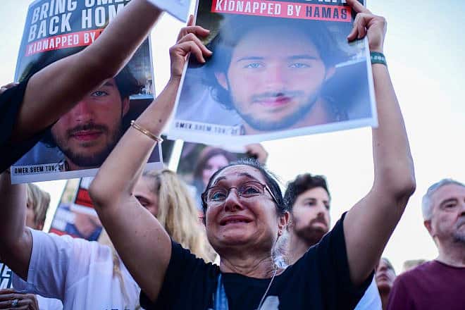 Families of Israelis held hostage by Hamas terrorists in the Gaza Strip hold up photographs outside of the Tel Aviv Museum of Art on Oct. 26, 2023. Photo by Tomer Neuberg/Flash90.