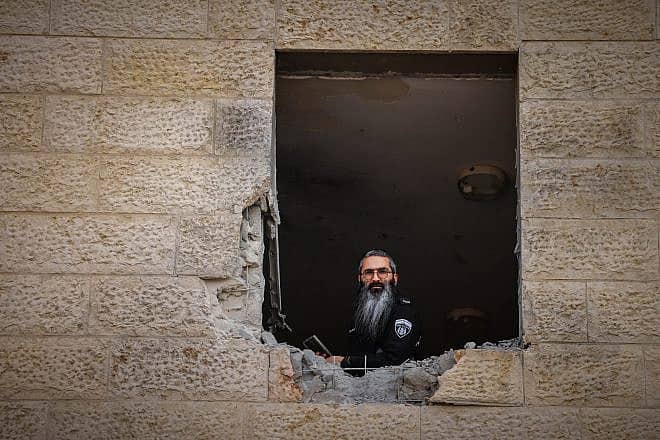 Israeli security forces at the scene where a rocket fired from Hamas the Gaza Strip hit and caused damage in the southern Israeli city of Sderot, Oct. 23, 2023. Photo by Chaim Goldberg/Flash90.