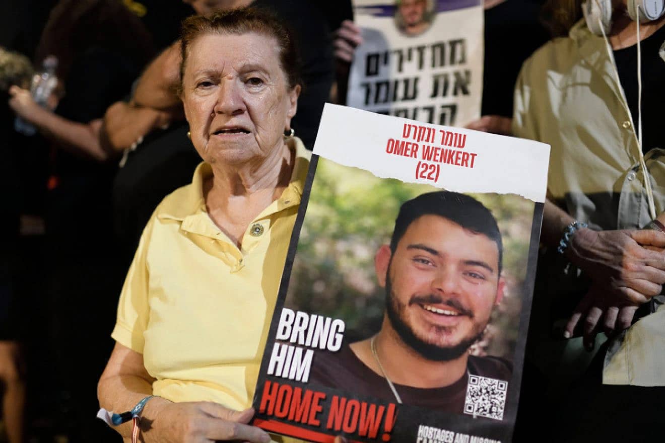 Holocaust survivor Tzili Wenkert holds a placard depicting her grandson Omer Wenkert, whom Hamas is holding captive in the Gaza Strip, at an event at "Hostages Square" outside the Tel Aviv Museum of Art on Oct. 28, 2023. Photo by Gili Yaari/Flash90.
