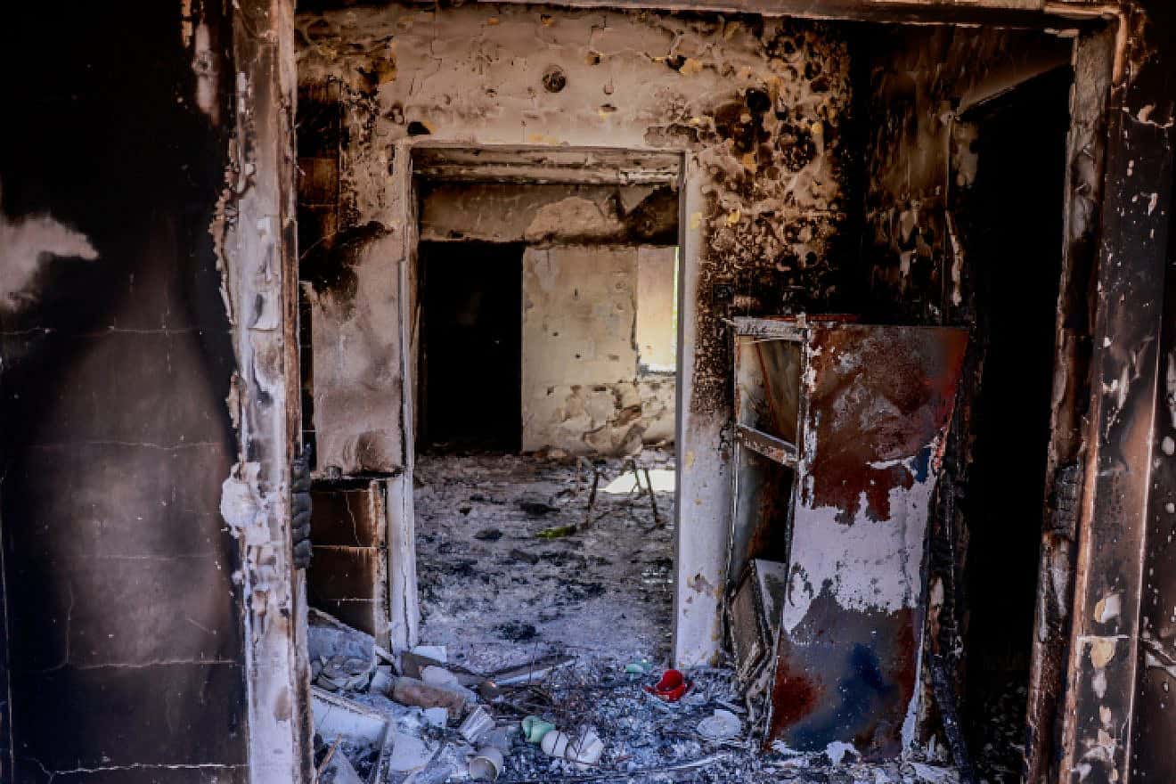 Israeli soldiers around the destruction caused by Hamas terrorists in Kfar Aza, near the Gaza border in southern Israel, Oct. 10, 2023. Photo by Chaim Goldberg/Flash90.