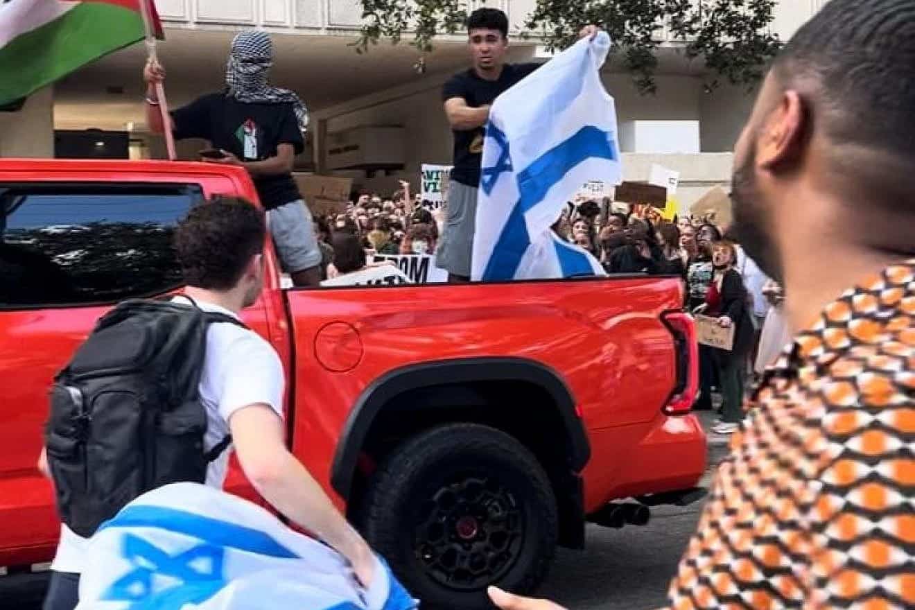 Anti-Israel protesters start to burn an Israeli flag during a rally at Tulane University in New Orleans, Oct. 26, 2023. Photo by Pnina Sasson.