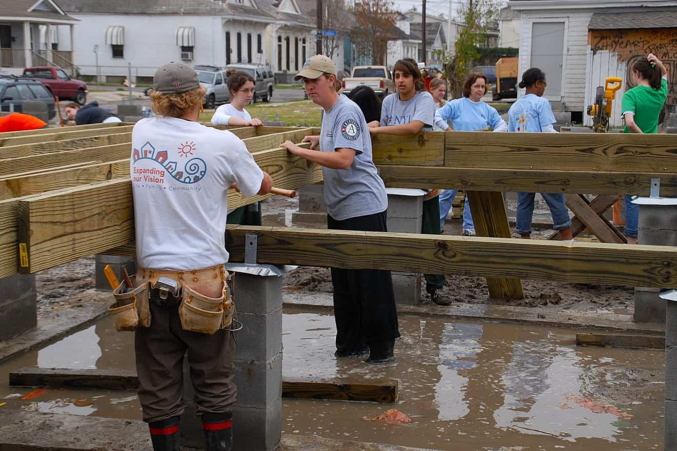 Volunteers from AmeriCorps place a floor joist on a Habitat for Humanity home being built in New Orleans, Jan. 21, 2006. Credit: Marvin Nauman/FEMA Photo Library via Wikimedia Commons.