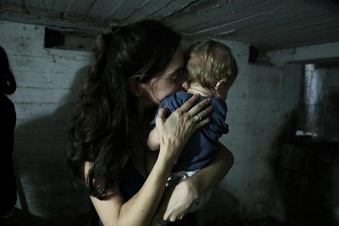 Israelis take cover in a bomb shelter in Tel Aviv during a rocket barrage, Nov. 1, 2023. Photo by Gideon Markowicz/TPS.