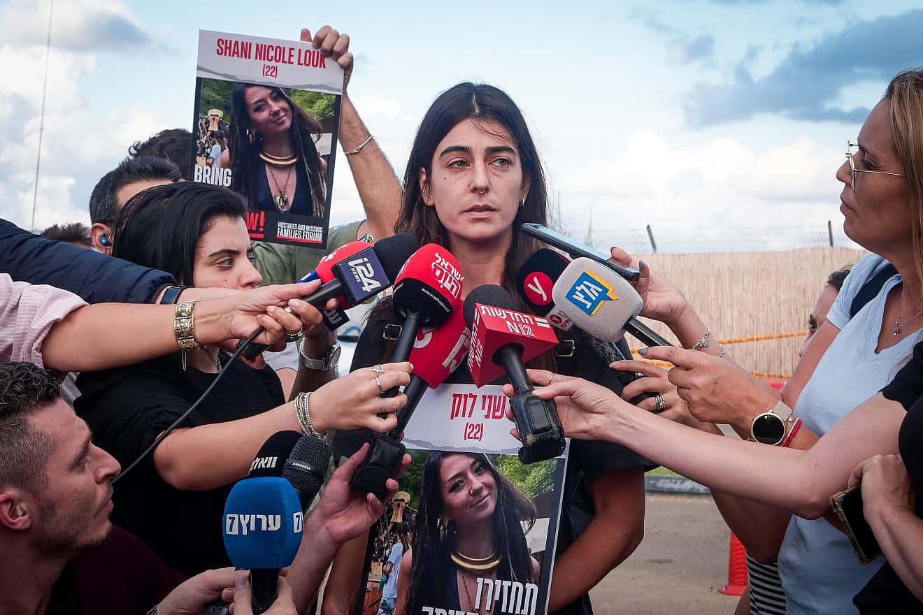 A cousin of Shani Louk, who was first thought abducted by Hamas terrorists in the attacks on Oct. 7 but later revealed to have been one of 1,400 people murdered that Saturday morning in southern Israel, speaks to the media outside the Home Front Command base in Ramle on Oct. 15, 2023. Photo by Avshalom Sassoni/Flash90.