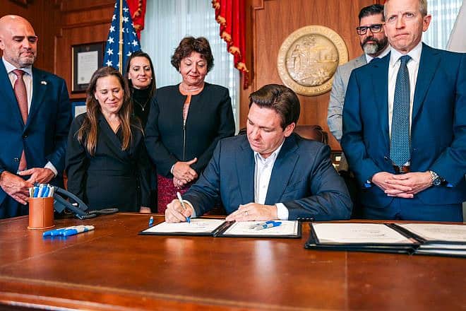 Florida Gov. Ron DeSantis signs the historic bill to increase security funding for Jewish institutions. Credit: Courtesy.