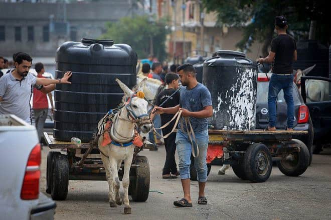 Palestinian civilians wait to collect water in Rafah in the southern Gaza Strip, Oct. 28, 2023. Photo by Abed Rahim Khatib/Flash90.