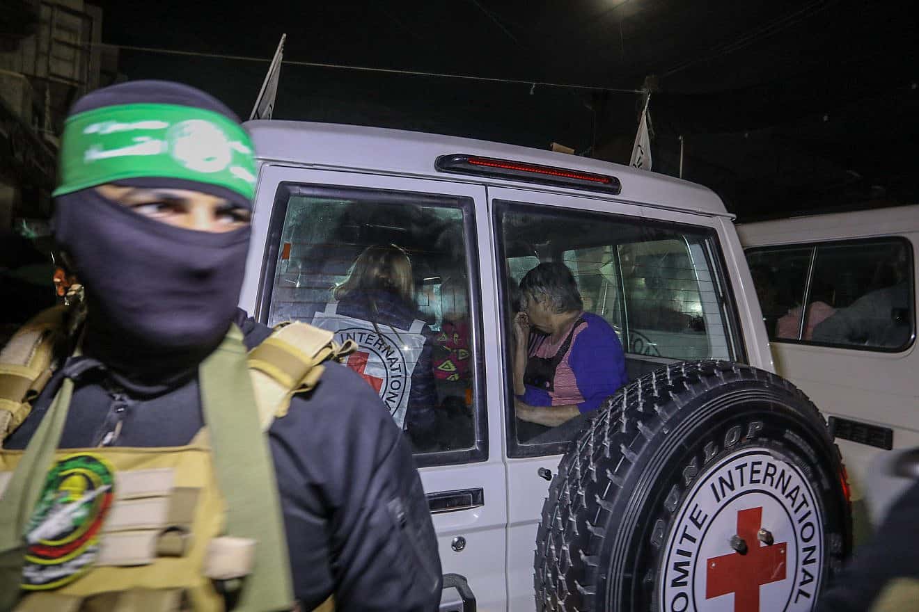 A Hamas terrorist releases Israeli hostages to the Red Cross, in Rafah, the southern Gaza Strip, Nov. 28, 2023. Credit: Flash90.