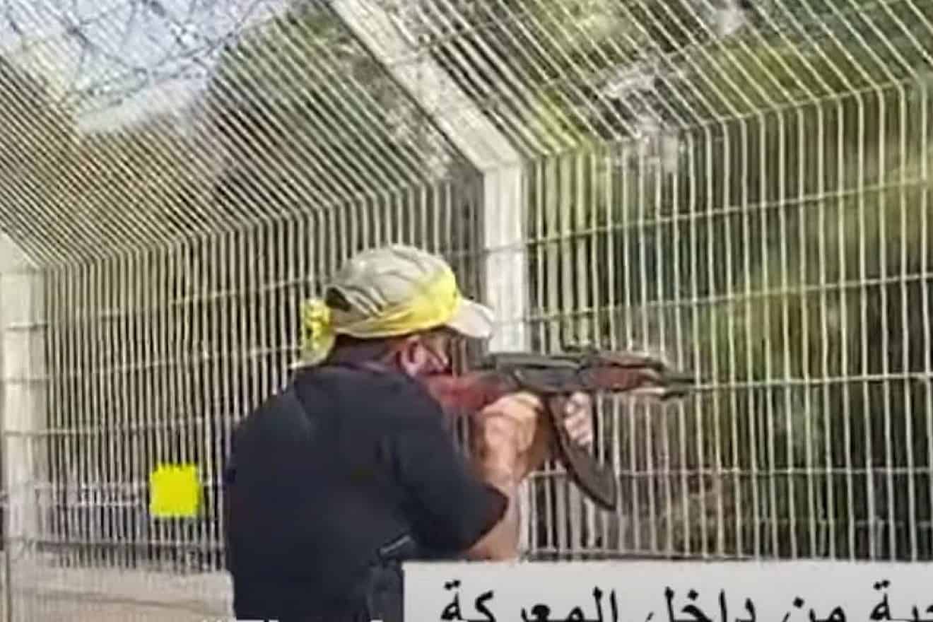 A terrorist from Fatah's Al-Aqsa Martyrs Brigades fires into a kibbutz near Gaza, Oct. 7, 2023. Screenshot by Palestinian Media Watch.