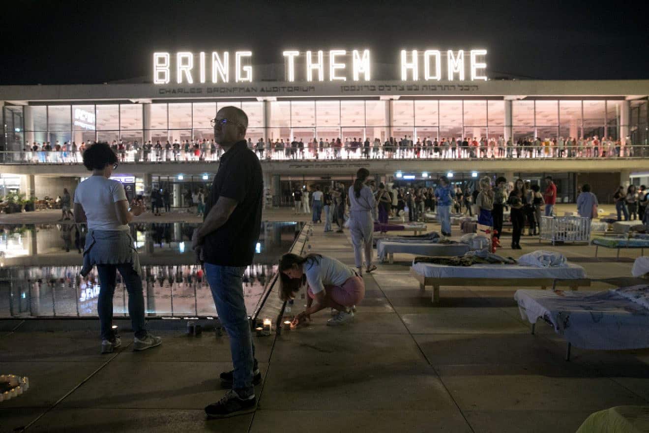 Israelis at Habimah Square in Tel Aviv walk by beds representing the number of hostages held captive by Hamas terrorists in the Gaza Strip, Nov. 11, 2023. Photo by Miriam Alster/Flash90.