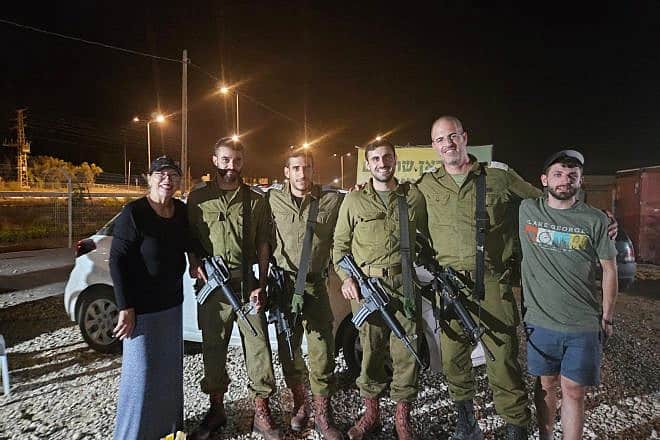 American Israel Tolchinsky (right) and another volunteer with IDF soldiers. Credit: Courtesy.
