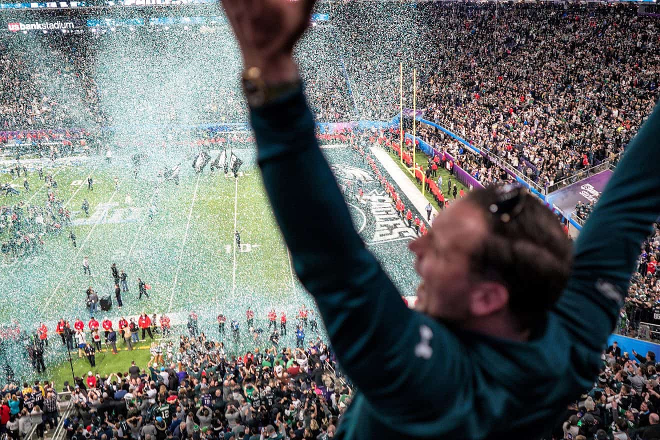 A Philadelphia  Eagles fan celebrates as confetti falls on the field in Minneapolis at Super Bowl 2018. Credit: Lorie Shaull via Wikimedia Commons.
