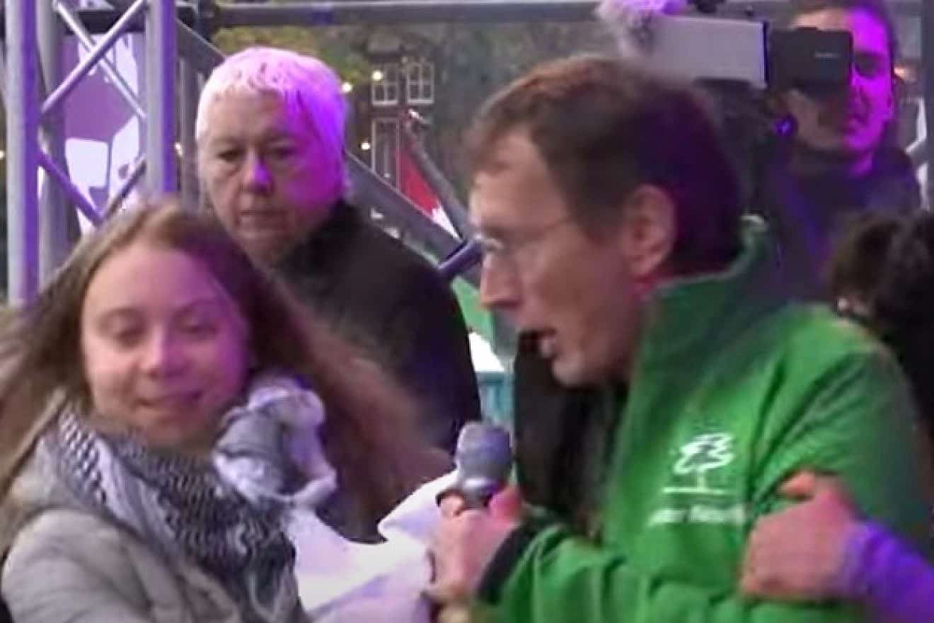 A man interrupts Swedish climate crusader Greta Thunberg at a climate protest in Amsterdam, Nov. 12, 2023. Source: YouTube screenshot.