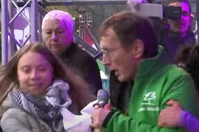 A man interrupts Swedish climate crusader Greta Thunberg at a climate protest in Amsterdam, Nov. 12, 2023. Source: YouTube screenshot.