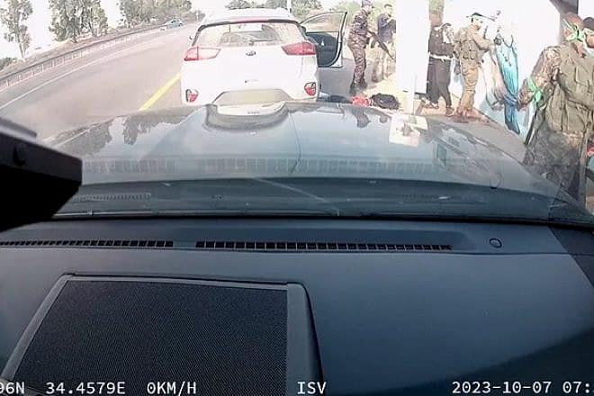 Screenshot from video of Hamas terrorists outside of a public bomb shelter full of people attending the Nova music festival near Re'im, Oct. 7, 2023. Source: X.