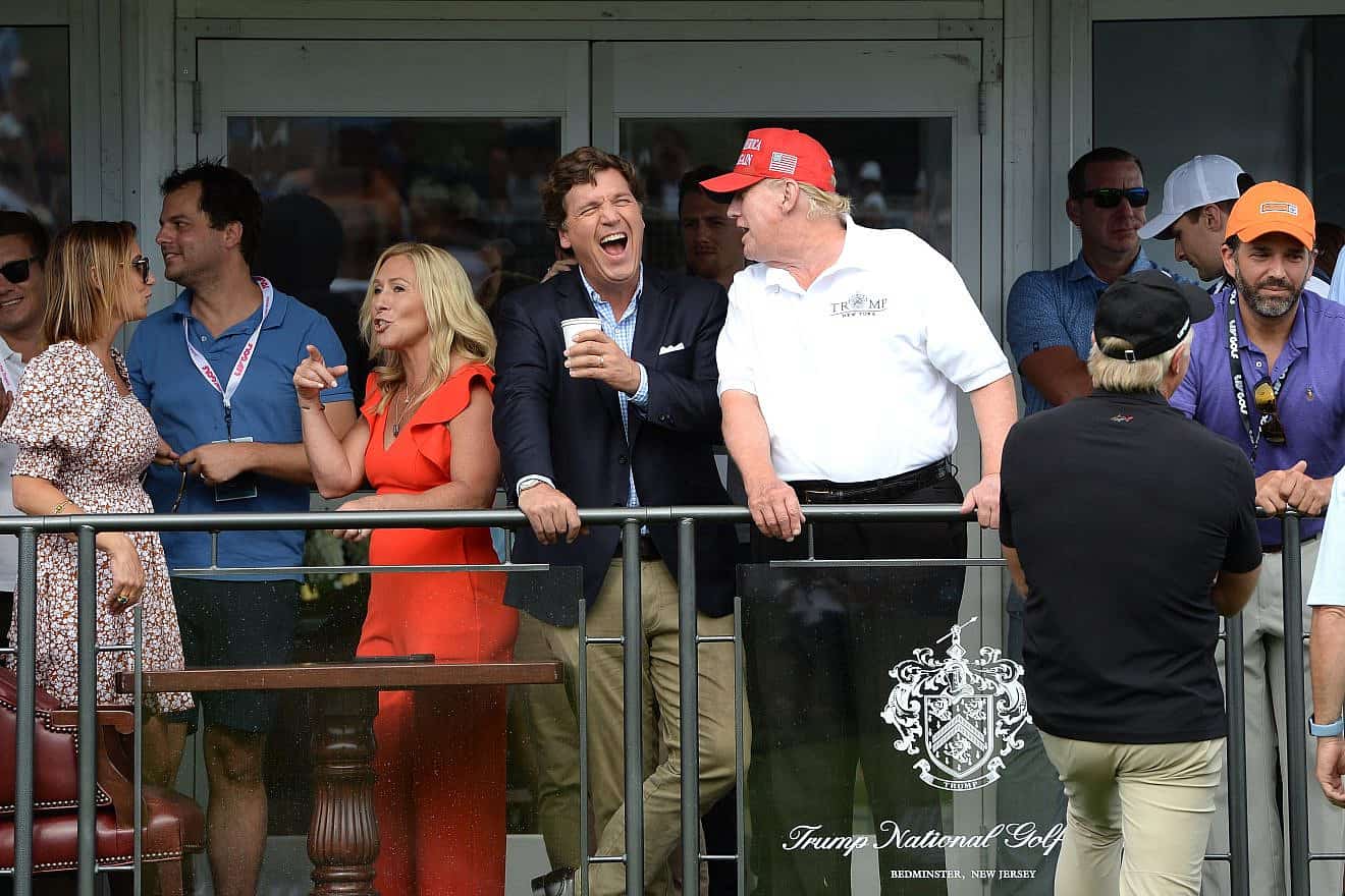 Tucker Carlson with former President Donald Trump at the 16th hole during the final LIV Golf Tournament held at the Trump National Golf Club in Bedminster, N.J., on July 31, 2022. Credit: L.E.MORMILE/Shutterstock.