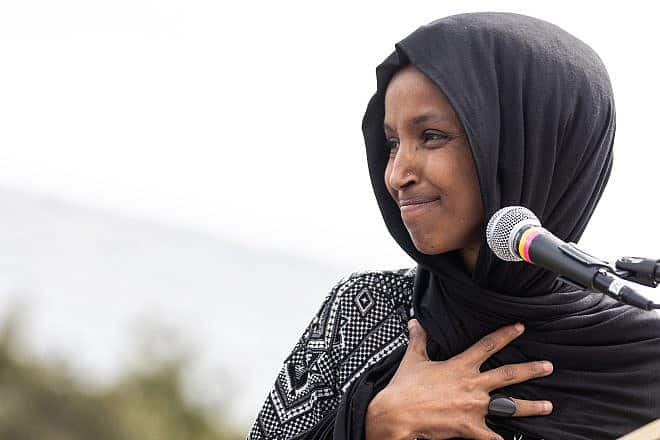 Rep. Ilhan Omar (D-Minn.) looks back at her daughter offstage as she addresses the crowd at the 2019 Youth Climate Strike in Washington. Credit: Paris Malone/Shutterstock.