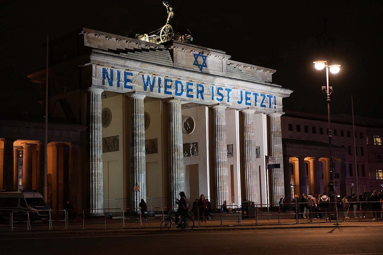 "Never Again Is Now" projected on Brandenburg Gate in Berlin on Nov. 9, 2023. Credit: Achim Wagner/Shutterstock.