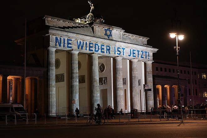 "Never Again Is Now" projected on Brandenburg Gate in Berlin on Nov. 9, 2023. Credit: Achim Wagner/Shutterstock.