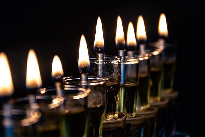 Chanukiyah with oil candles. Credit: Ri-Ya/Pixabay.