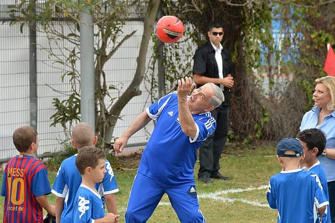 Israeli Prime Minister Benjamin Netanyahu plays soccer with young children sick with cancer and F.C. Barcelona players in Jaffa's Bloomfield Stadium, near Tel Aviv, Aug. 4, 2013. Photo by Yossi Zeliger/Flash90.