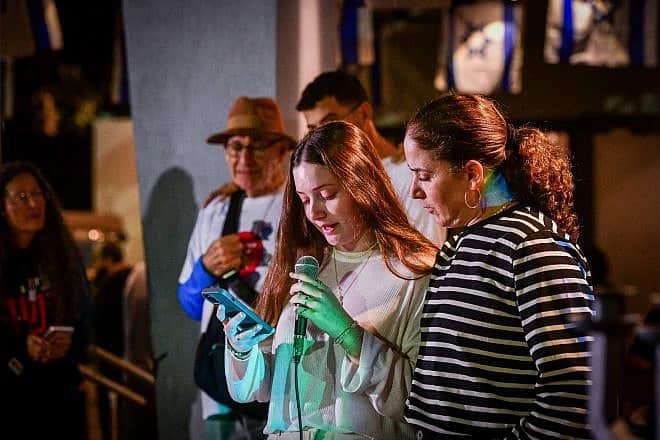 Chen Goldstein-Almog and her daughter Agam light Chanukah candles together with other members of Kibbutz Kfar Aza in Shefayim, Dec. 10, 2023. Photo by Avshalom Sassoni/Flash90.