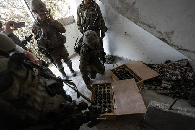 Israeli soldiers display grenades captured during a raid at the Jabalia refugee camp, in the northern Gaza Strip, Dec. 12, 2023. Photo by Chaim Goldberg/Flash90.