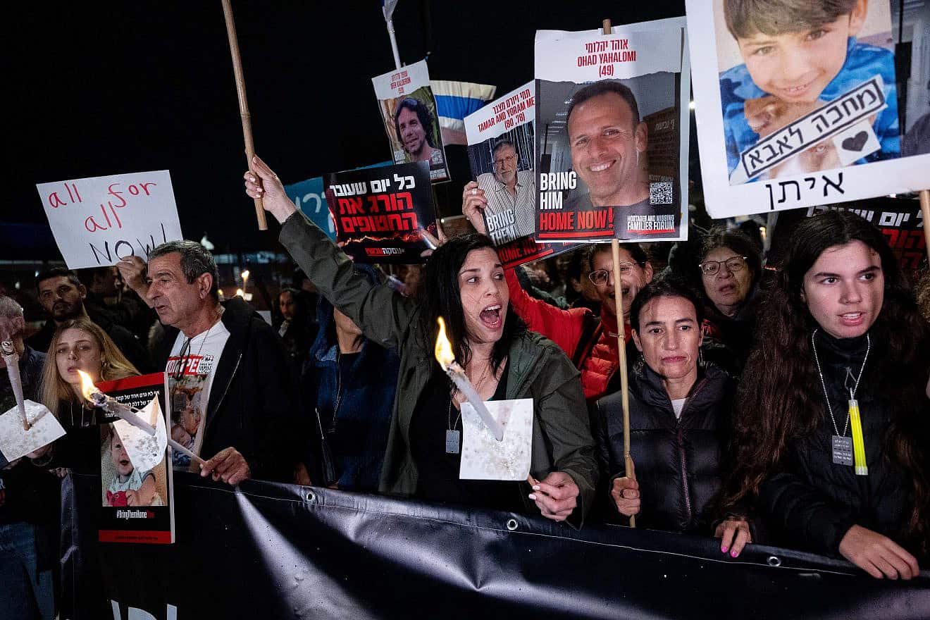 Israelis and families of Israelis held hostage by Hamas terrorists in Gaza, hold torches as they march towards the Israeli parliament in Jerusalem, on the fifth night of the Jewish holiday of Chanukah, as they call for the release of the hostages. Dec. 12, 2023. Photo by Yonatan Sindel/Flash90.