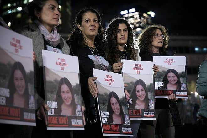 In Tel Aviv, relatives and friends of Israelis being held captive in the Gaza Strip by Hamas terrorists hold photos of their loved ones, Dec. 13, 2023. Photo by Miriam Alster/Flash90.