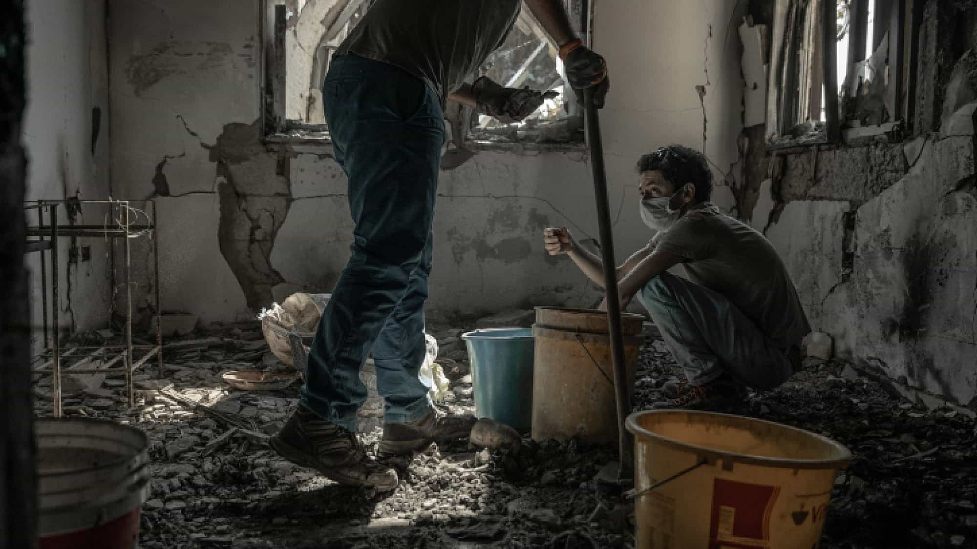 Members of a family whose father was murdered by Hamas terrorists on Oct. 7 search the rubble of his home in Kibbutz Be'eri on Nov. 30, 2023. Photo by Chen Schimmel/Flash90.